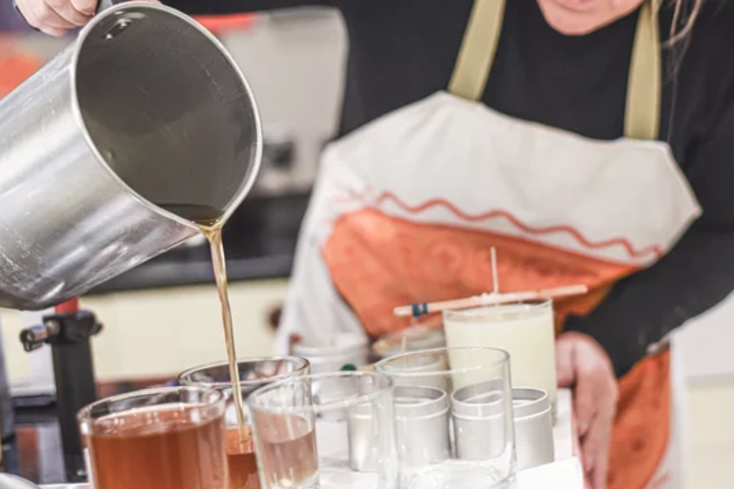 Woman hand-pouring candles at Rambling Caravan.