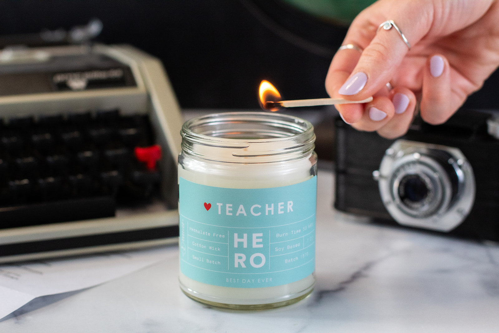 Teacher Hero candle being lit with a match.