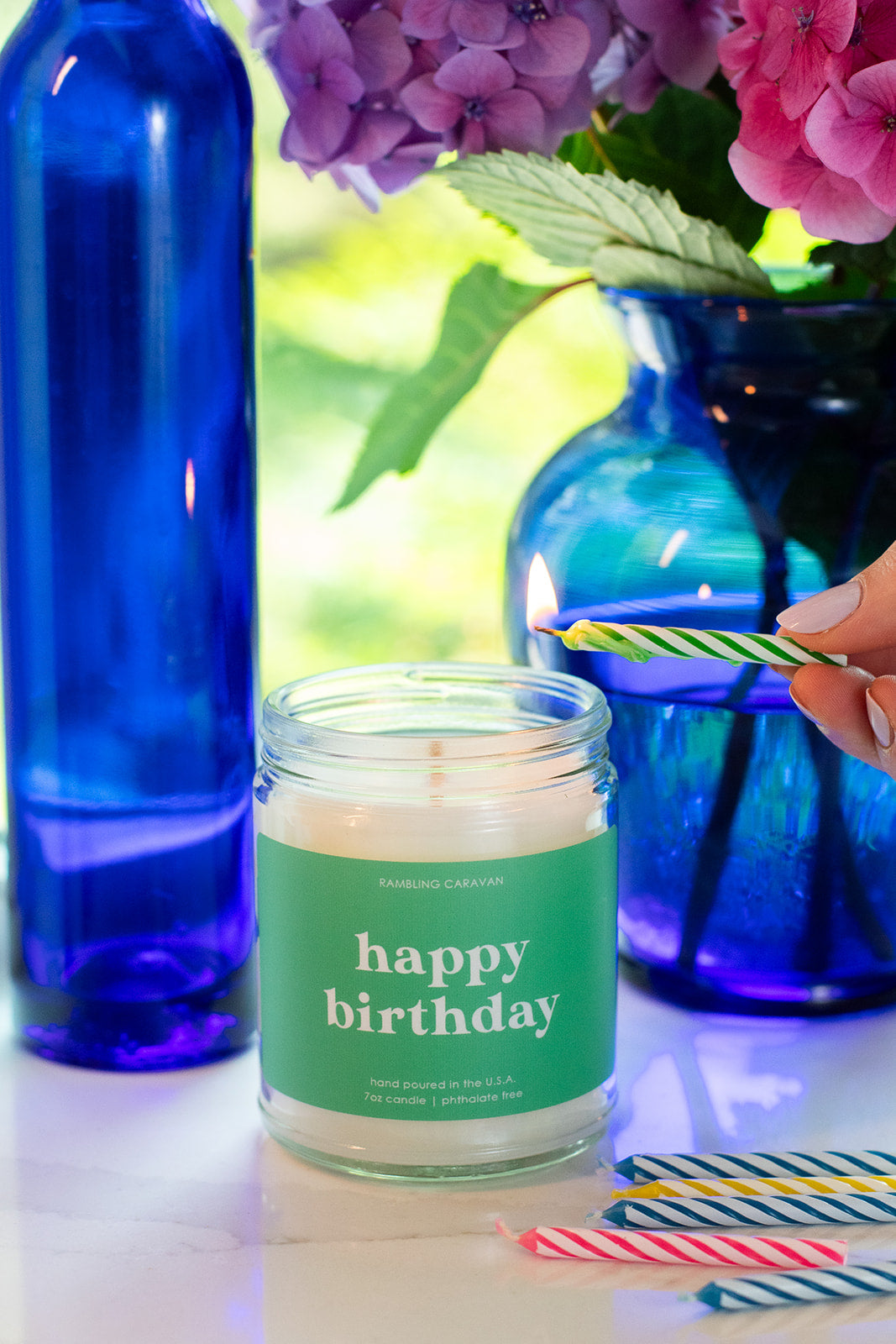 Happy Birthday candle being lit by a birthday candle.