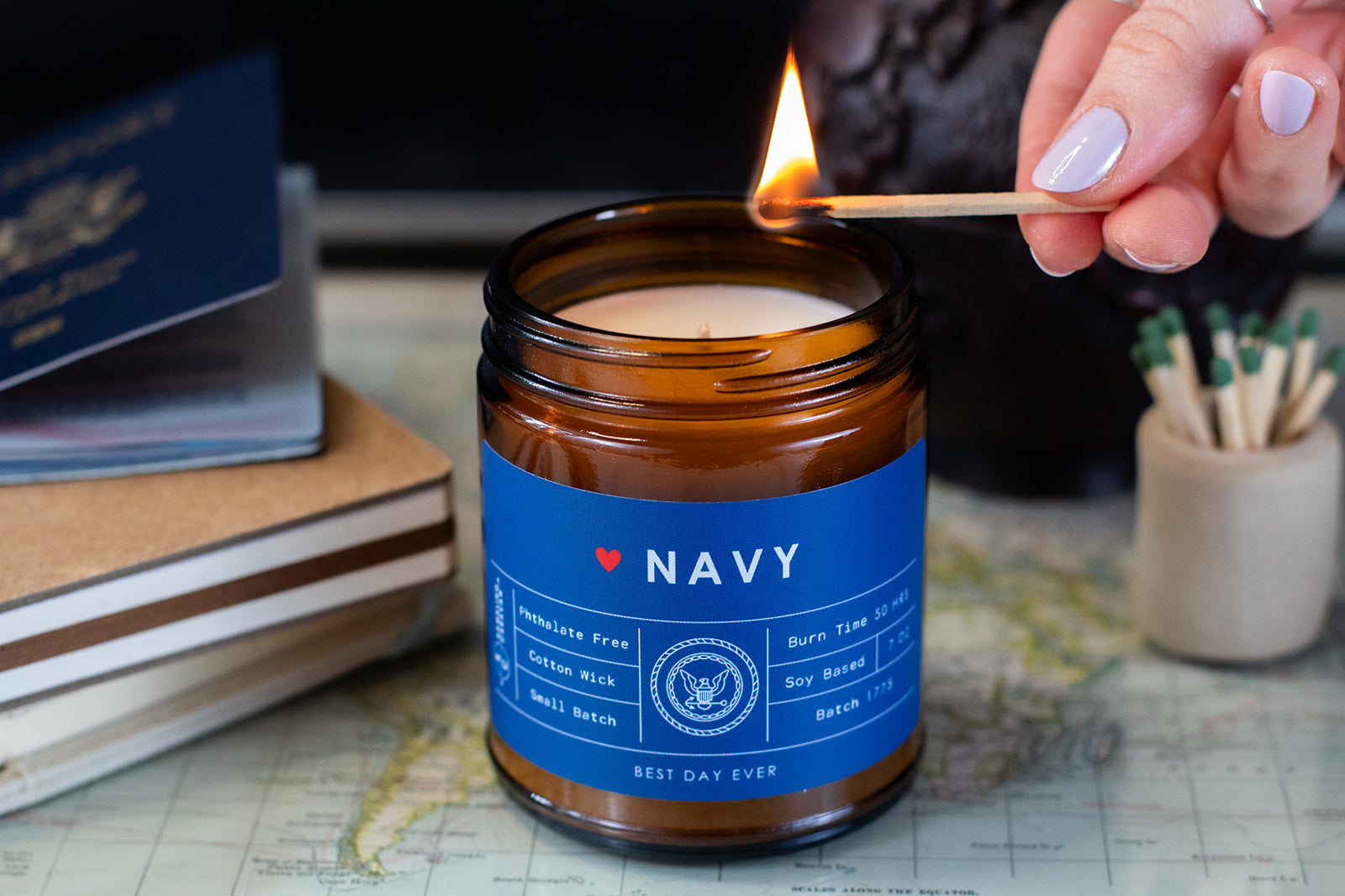 Lighting dark blue U.S. Navy candle with a match.